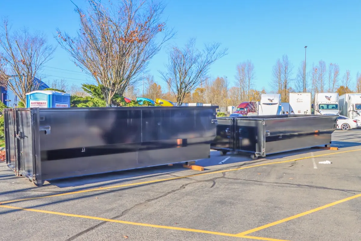 Professional dumpster rental service with roll-off container on residential driveway in Elkhorn